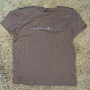 Light brown “freedom” t-shirt. Size small.
